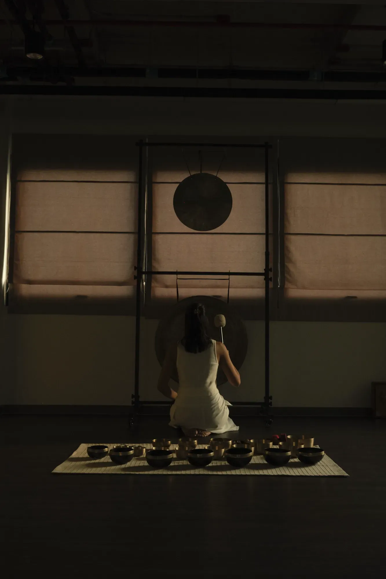 Ice playing a gong at Attuned Studio in Bangkok.